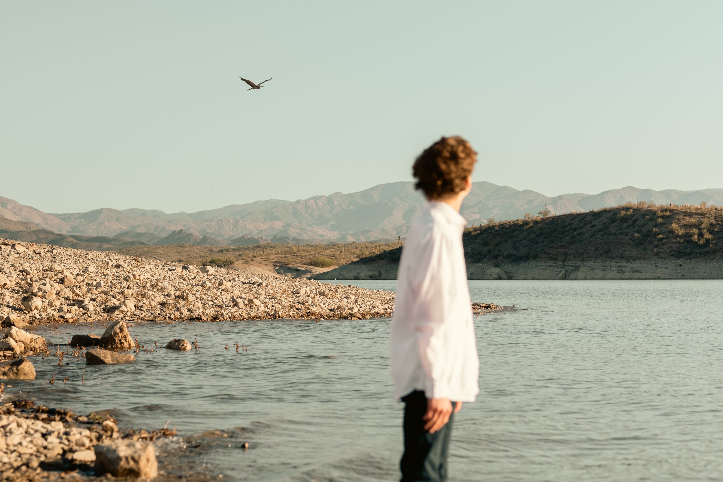 Woman looking out over a lake and mountains